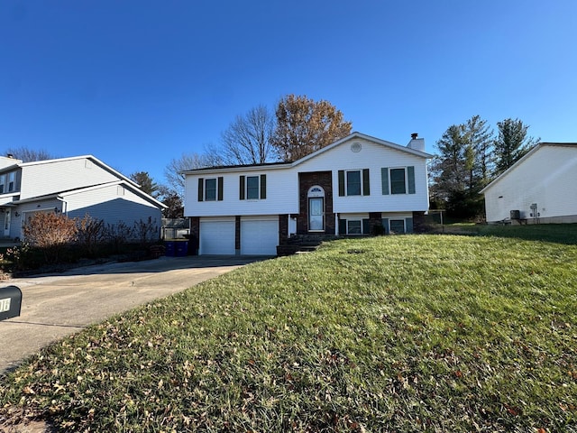 split foyer home featuring a front yard and a garage