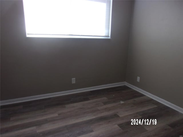 empty room with dark wood-type flooring