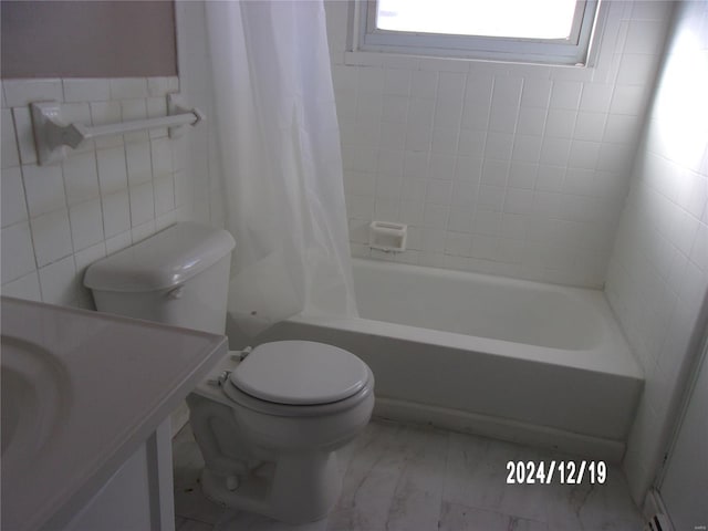 full bathroom featuring vanity, toilet, shower / bathtub combination with curtain, and tile walls