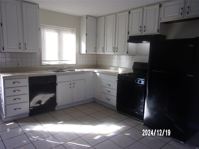 kitchen featuring black appliances, a sink, under cabinet range hood, white cabinetry, and light countertops