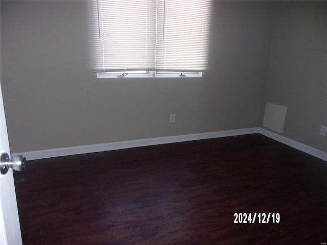 empty room featuring dark wood-type flooring