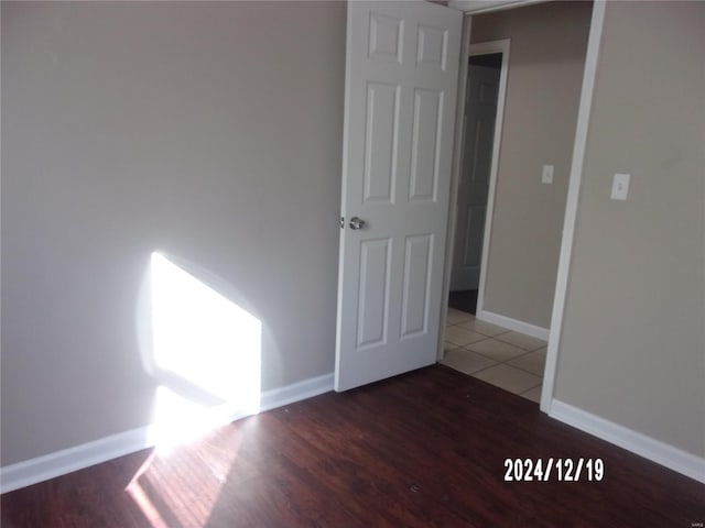 unfurnished room with wood-type flooring