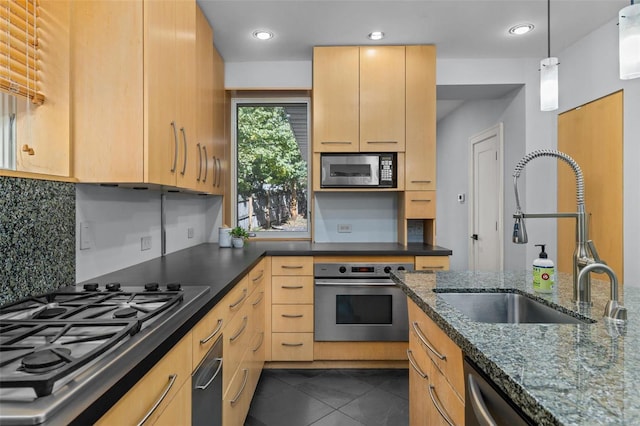 kitchen featuring a sink, stainless steel appliances, decorative backsplash, and light brown cabinets