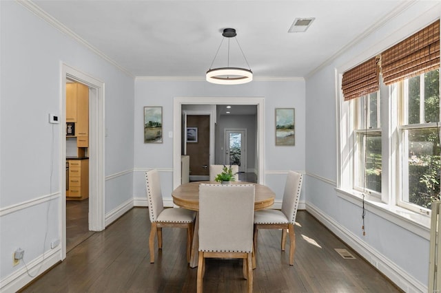 dining area featuring baseboards, a healthy amount of sunlight, dark wood-style floors, and crown molding