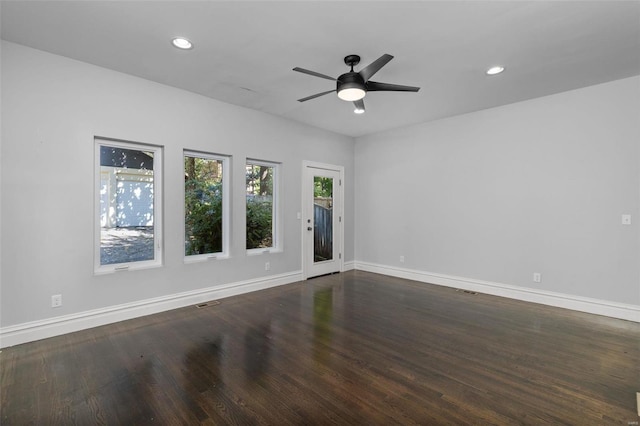 empty room featuring a ceiling fan, recessed lighting, baseboards, and dark wood-style flooring