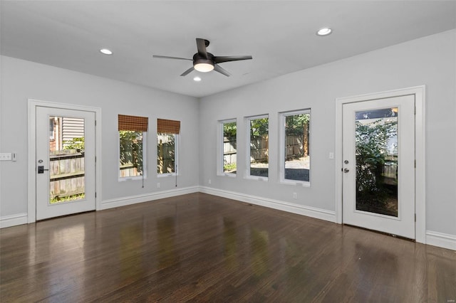 interior space with wood finished floors, recessed lighting, a healthy amount of sunlight, and baseboards