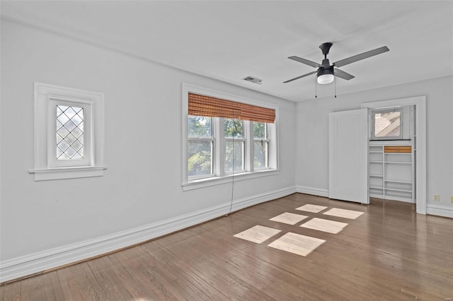 unfurnished bedroom with visible vents, baseboards, and wood finished floors