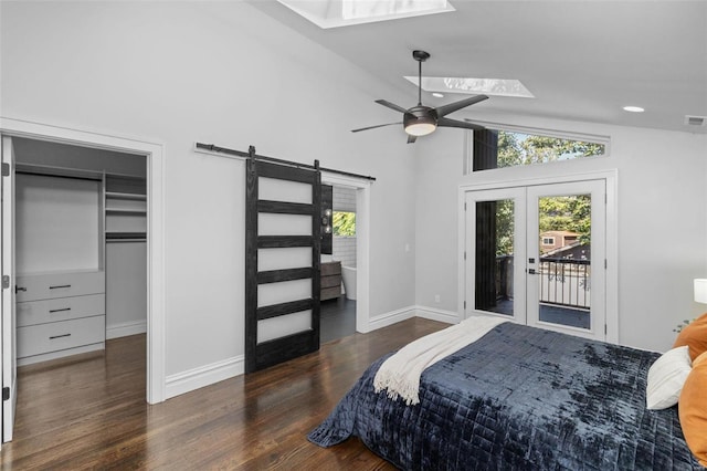 bedroom featuring access to exterior, visible vents, baseboards, a barn door, and wood finished floors