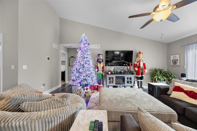 living room with lofted ceiling, wood-type flooring, and ceiling fan