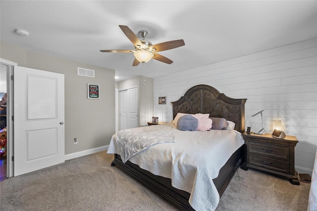 bedroom with ceiling fan, light colored carpet, and a closet