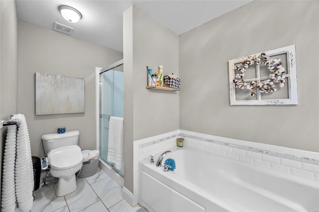 bathroom featuring a textured ceiling, shower with separate bathtub, and toilet