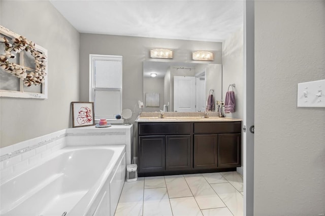 bathroom featuring tile patterned flooring, vanity, and a bath