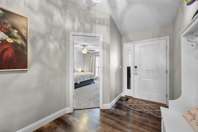 foyer entrance with ceiling fan and dark hardwood / wood-style flooring