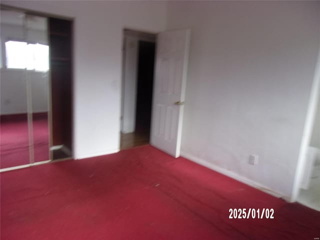 unfurnished bedroom with carpet flooring and a closet