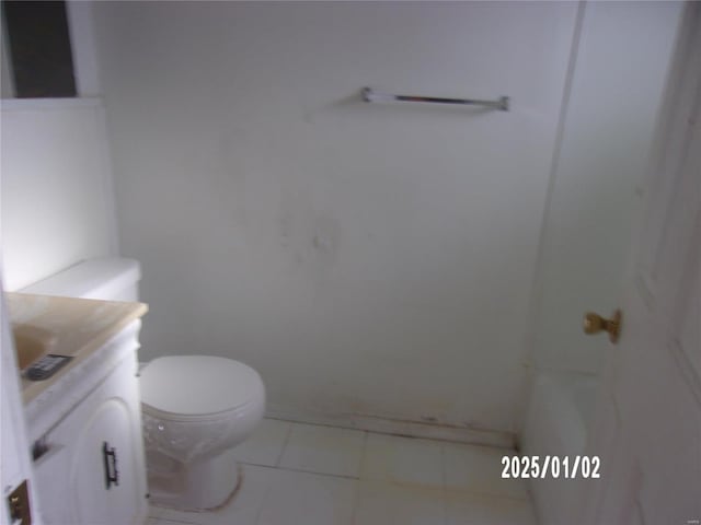 bathroom featuring toilet, vanity, and tile patterned floors