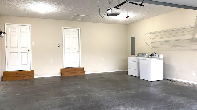 garage with washer and dryer, a garage door opener, and electric panel