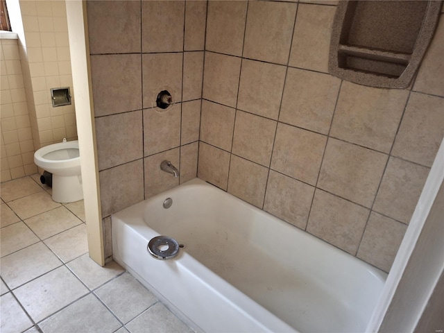 bathroom featuring tile patterned flooring, toilet, tile walls, and tiled shower / bath