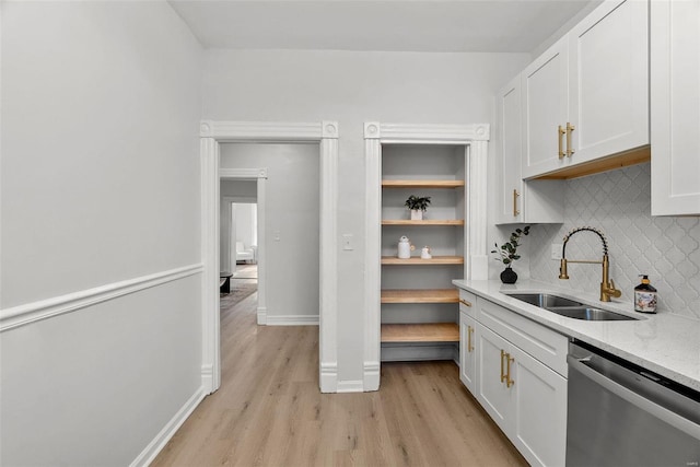 kitchen featuring dishwasher, light wood-type flooring, white cabinetry, and sink