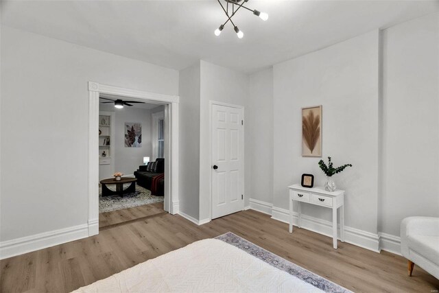 bedroom featuring hardwood / wood-style floors and a notable chandelier