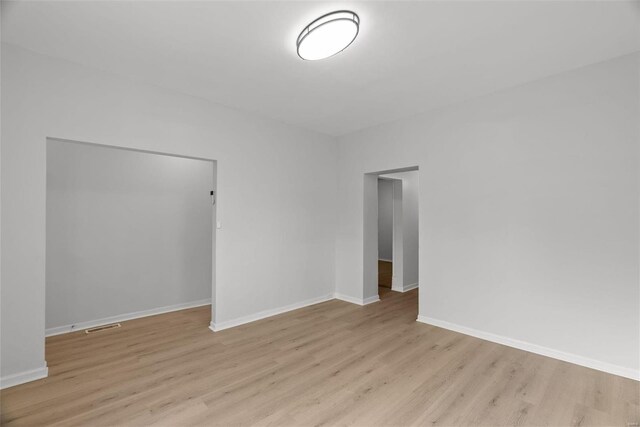 empty room with light hardwood / wood-style flooring