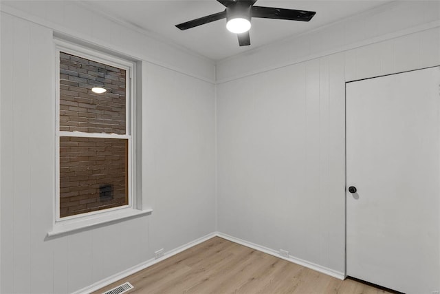 empty room with light hardwood / wood-style floors and ceiling fan