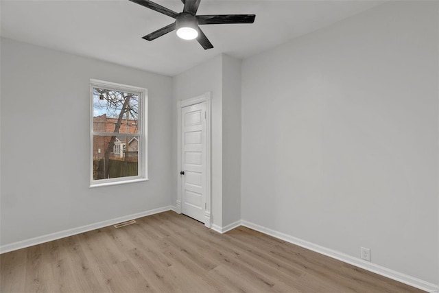 spare room featuring light wood-type flooring and ceiling fan