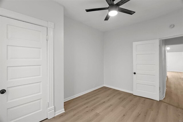 spare room with ceiling fan and light wood-type flooring