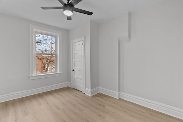 empty room featuring ceiling fan and light hardwood / wood-style flooring