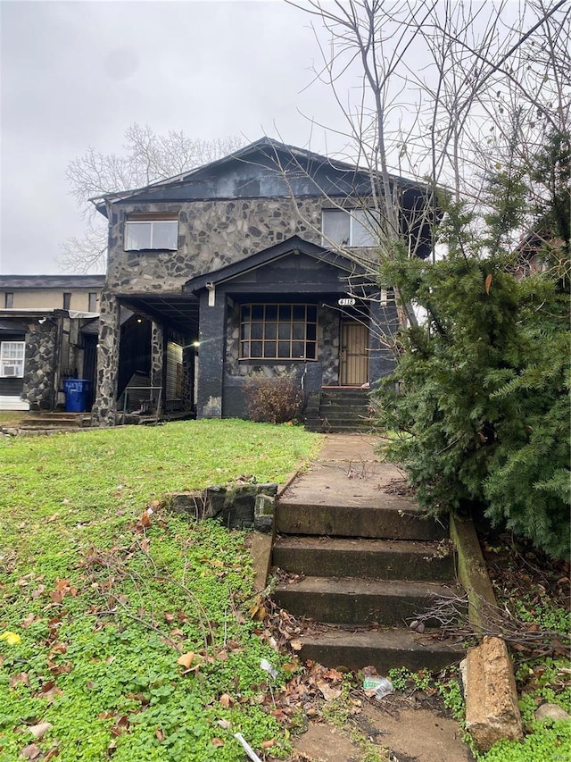 back of house with a lawn