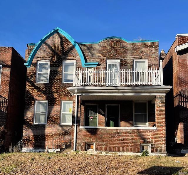 rear view of property with a balcony