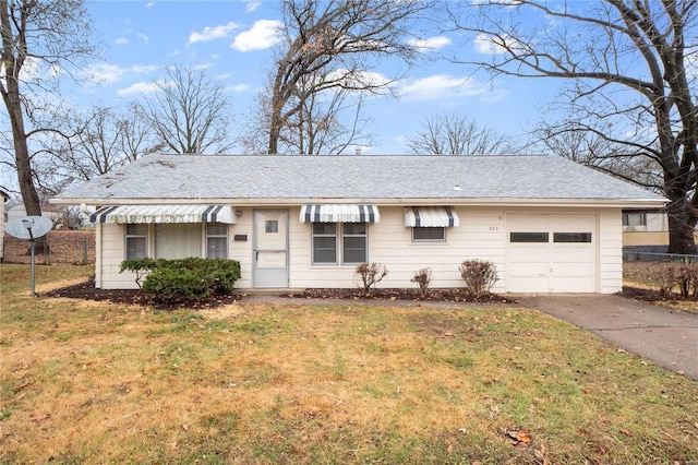 single story home featuring a garage and a front lawn