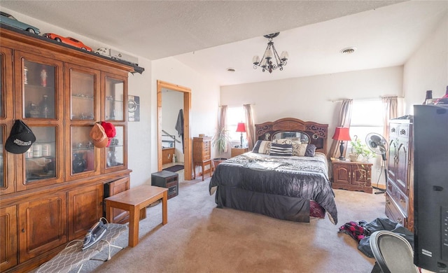 bedroom featuring multiple windows, light carpet, a chandelier, and a textured ceiling