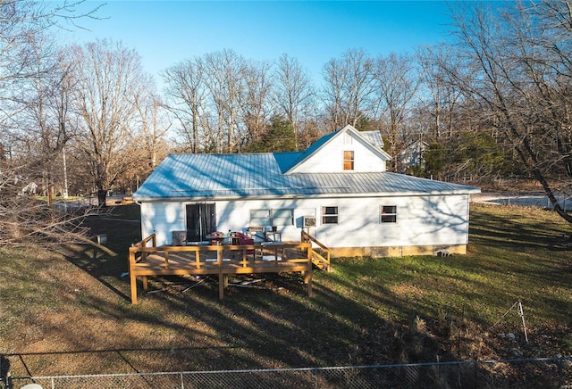 rear view of house featuring a lawn and a wooden deck