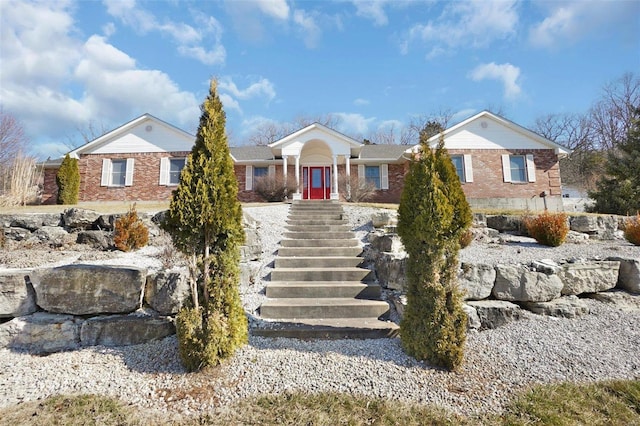 ranch-style home featuring brick siding