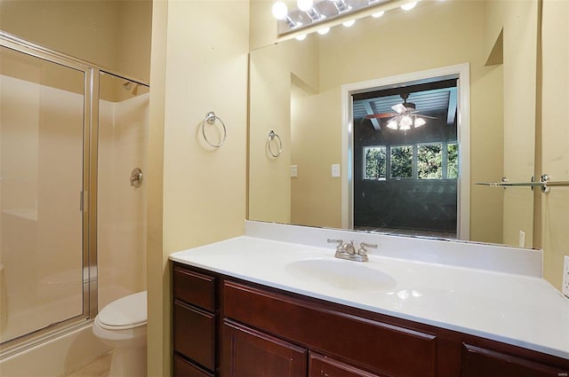 bathroom featuring ceiling fan, vanity, an enclosed shower, and toilet