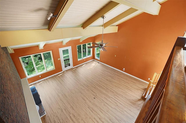 unfurnished living room with vaulted ceiling with beams, ceiling fan, and hardwood / wood-style floors