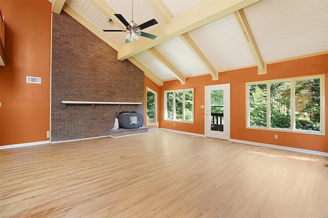 unfurnished living room featuring high vaulted ceiling, light hardwood / wood-style flooring, ceiling fan, beam ceiling, and brick wall