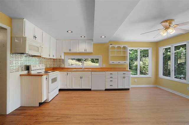 kitchen with white cabinetry, sink, white appliances, and wood counters