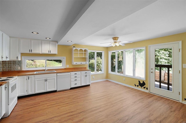 kitchen with white cabinets, wooden counters, and white appliances