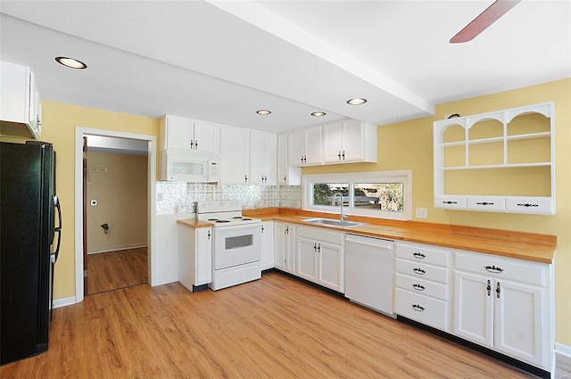 kitchen with butcher block counters, white cabinetry, and white appliances