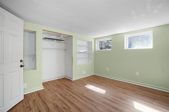 unfurnished bedroom featuring wood-type flooring and a closet