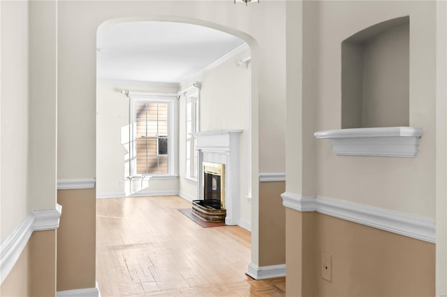 unfurnished living room with ornamental molding and a fireplace