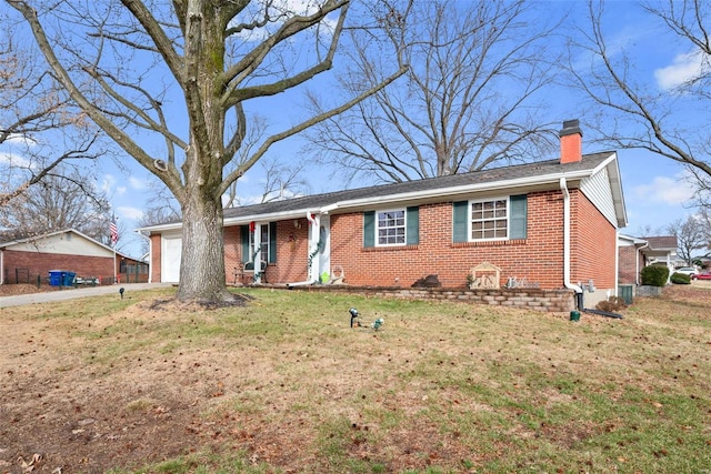 single story home featuring a garage and a front lawn