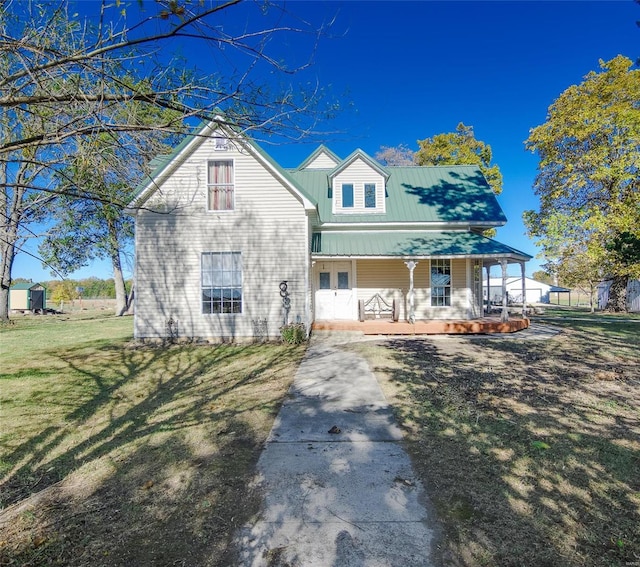 view of front of property featuring covered porch and a front yard