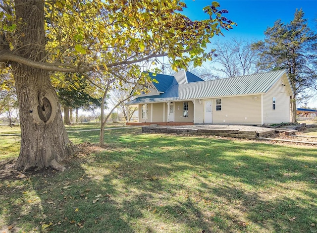 view of front of house with a patio and a front yard