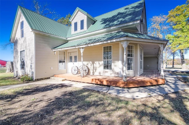 back of house featuring covered porch