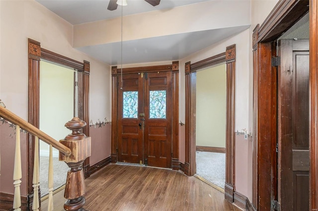 foyer featuring wood-type flooring, french doors, and ceiling fan