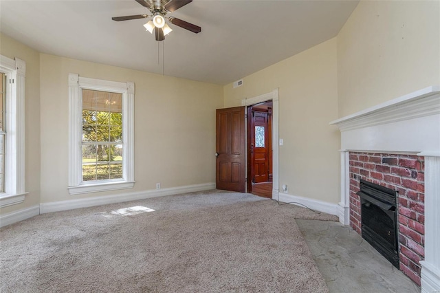 unfurnished living room with a fireplace, light colored carpet, and ceiling fan