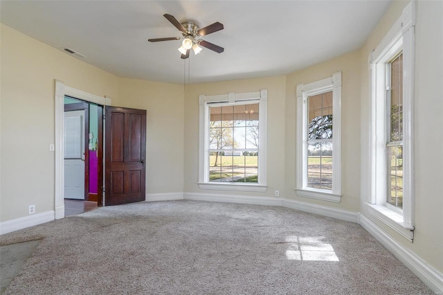 carpeted spare room featuring ceiling fan