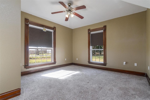 carpeted empty room featuring ceiling fan